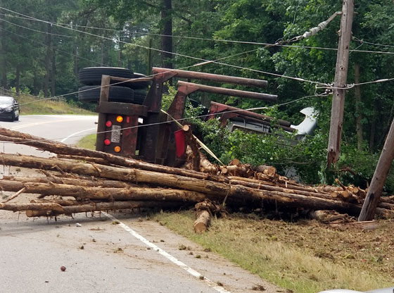 overturned log truck downs power lines