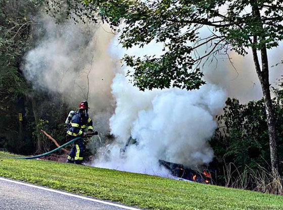 Firefighters battle car fire after crash