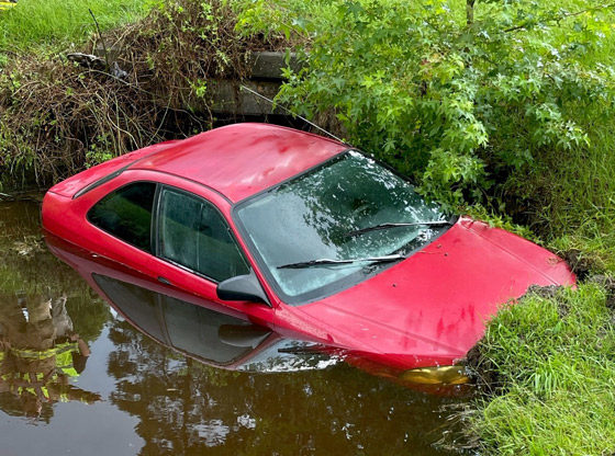 Car crashes into drainage pond