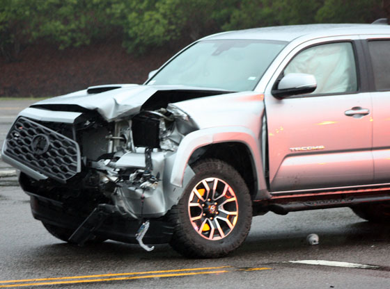 Rainy-day wreck traps driver in car