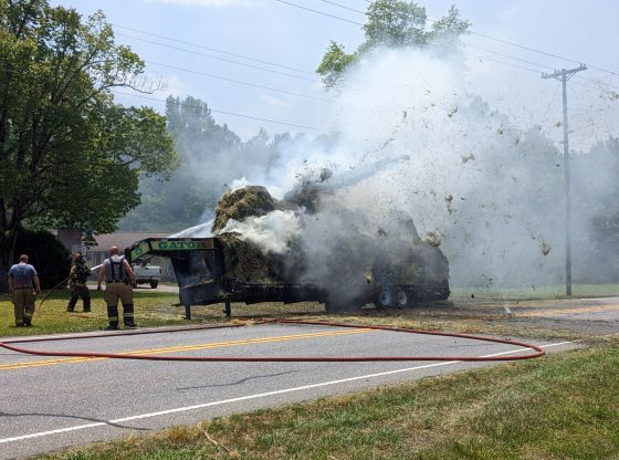Firefighters battle hay fire