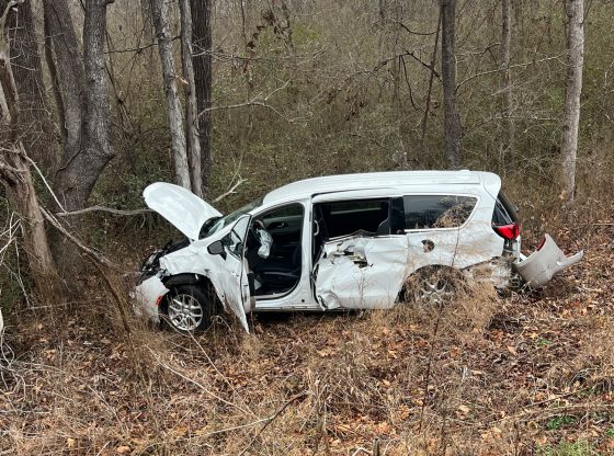 Group home van crashes through guardrail into woods