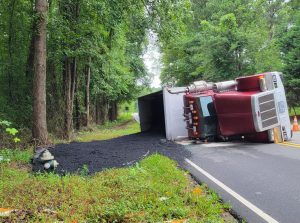 Overturned dump truck loses load in Carthage