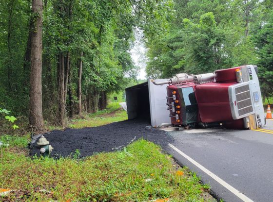 Overturned dump truck loses load in Carthage