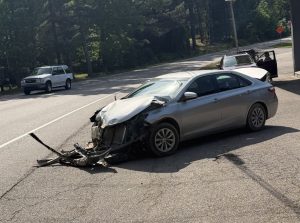 Car pushed into roadway, struck by semi