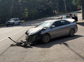 Car pushed into roadway, struck by semi