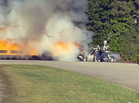 Car catches fire after striking school bus
