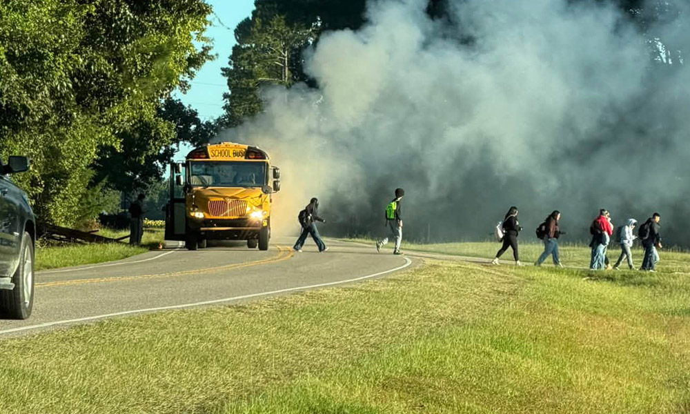 Car catches fire after striking school bus Friday
